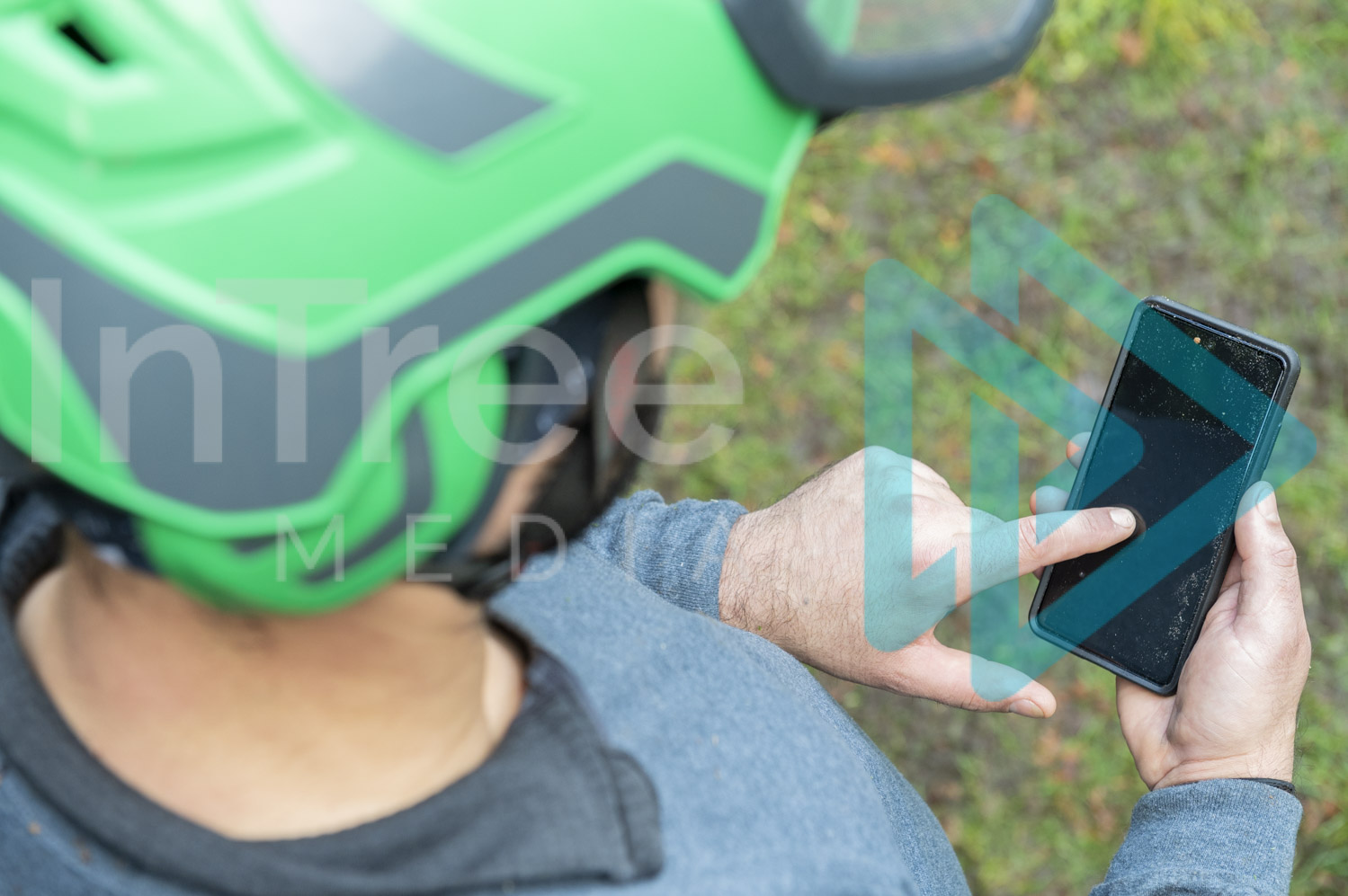 Male-arborist using smart phone with finger on screen - Arborist Stock Photo 001-21-7996