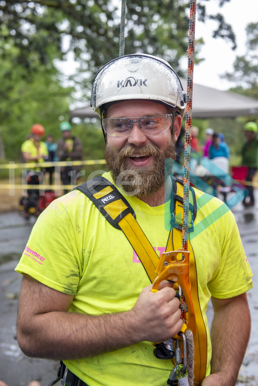 Male climbing arborist with big smile on his face ready to climb a rope