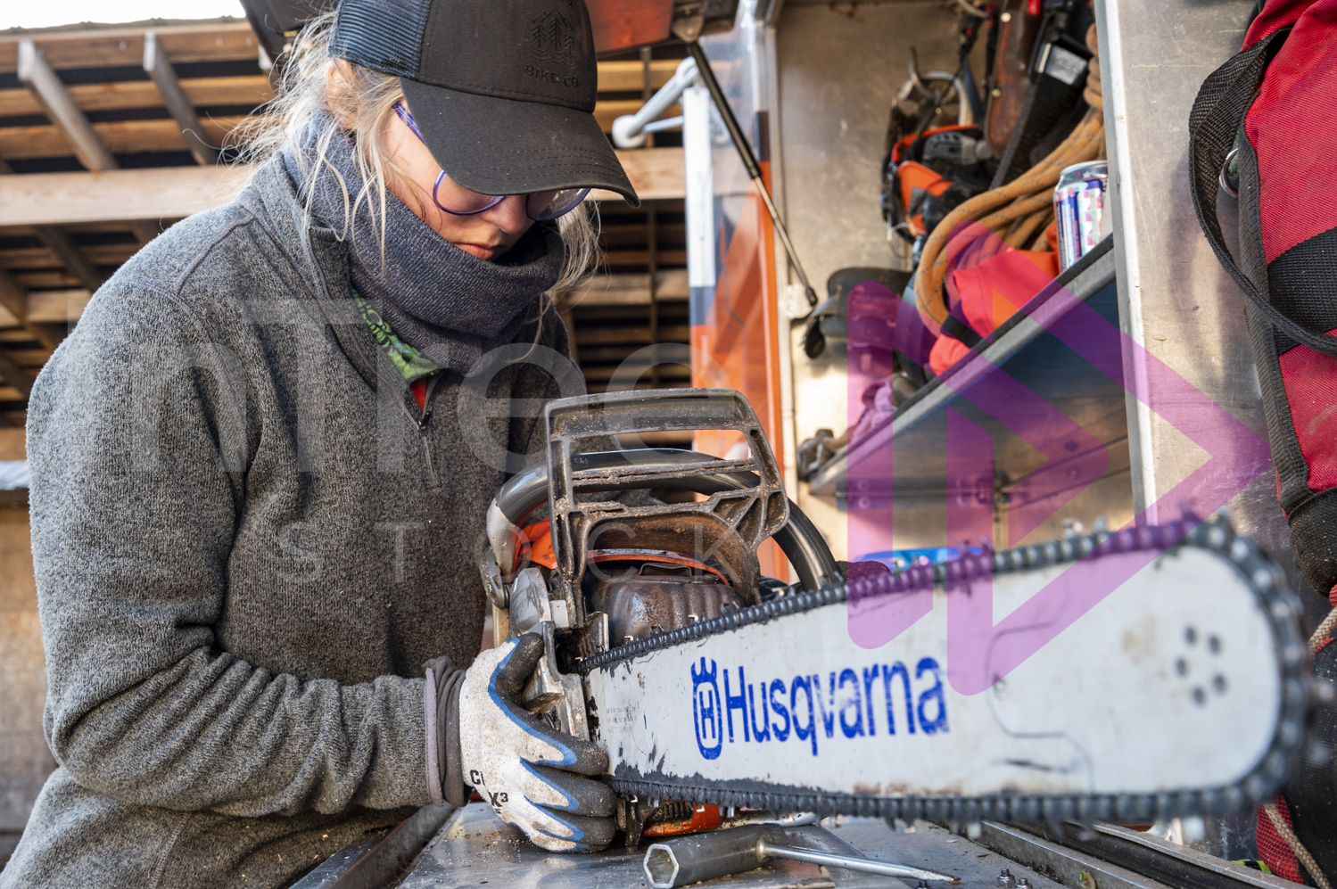 Chainsaw on chip truck with woman replacing the side cover