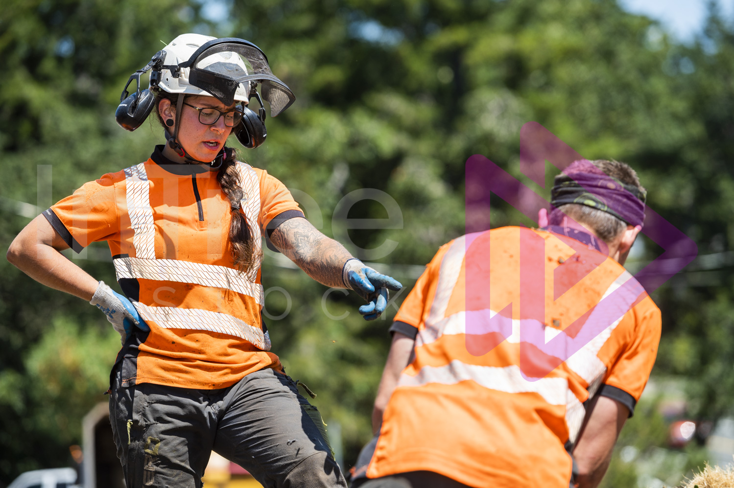 Female arborist communicating with male arborist