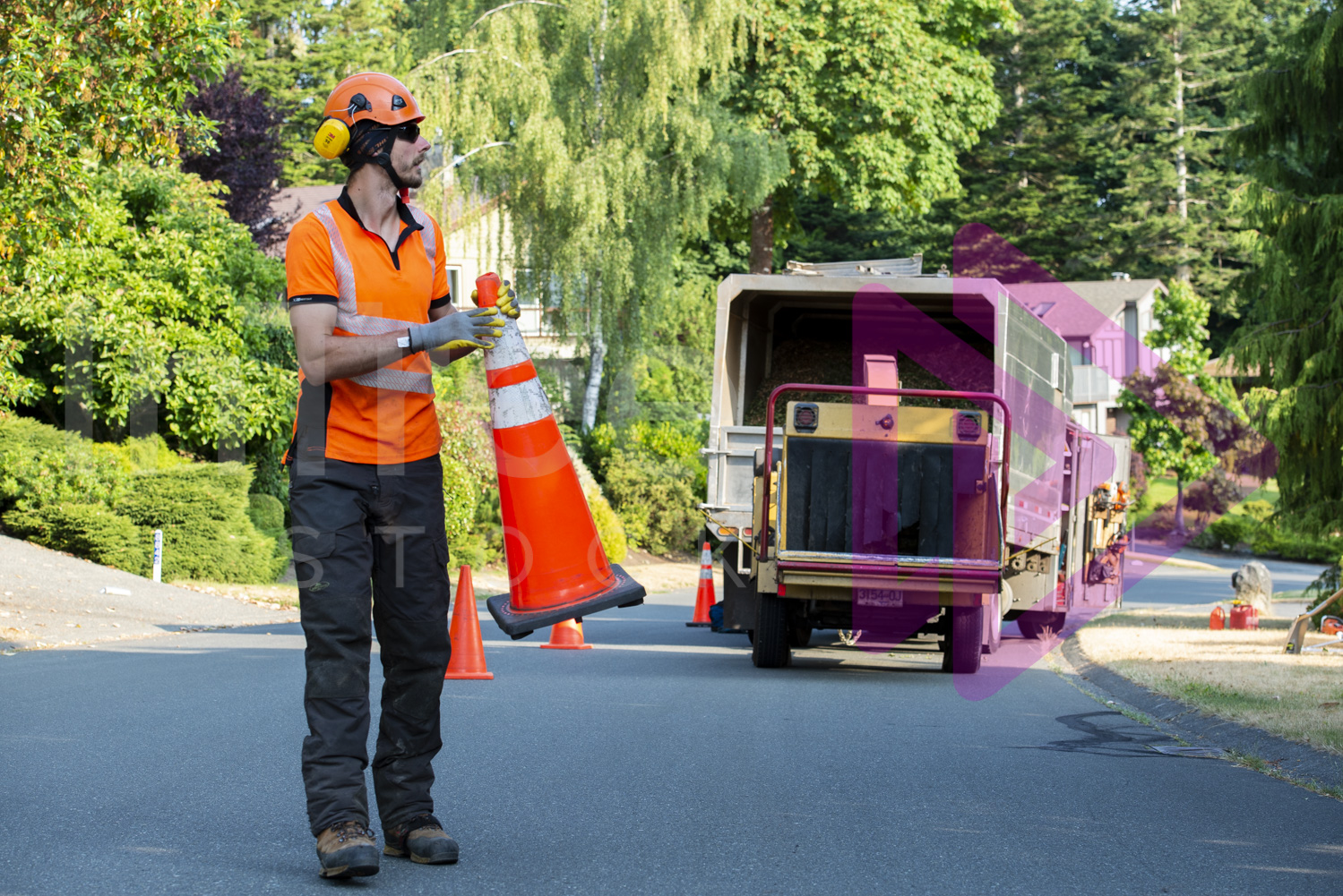 Man in hi-viz putting out traffic cones