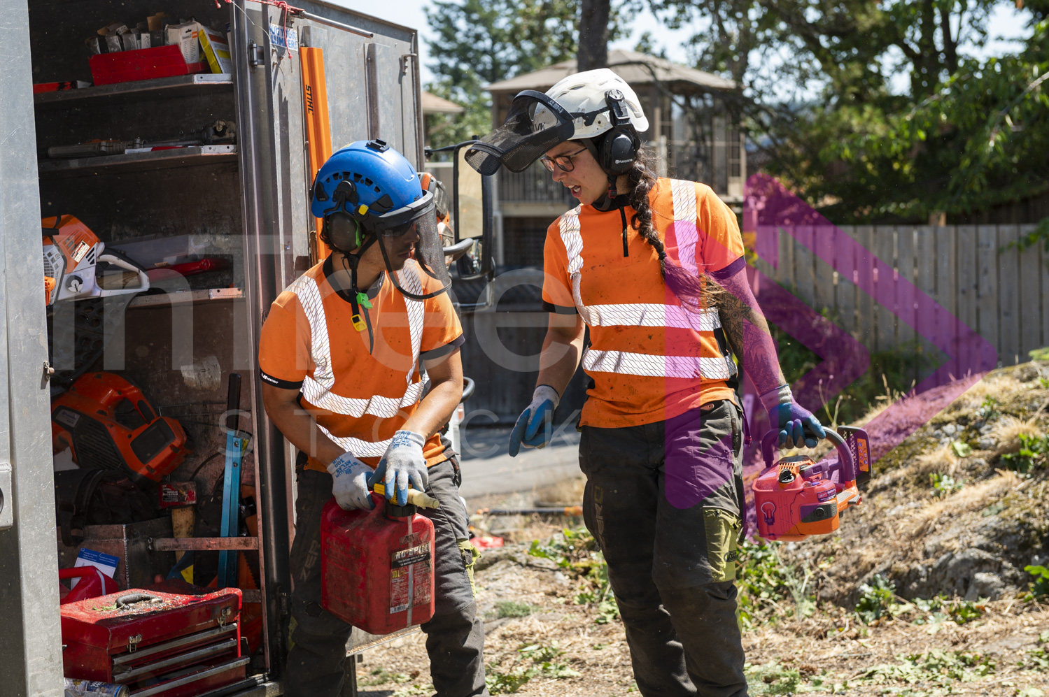 Female and male arborist communicating over fuelling chainsaw