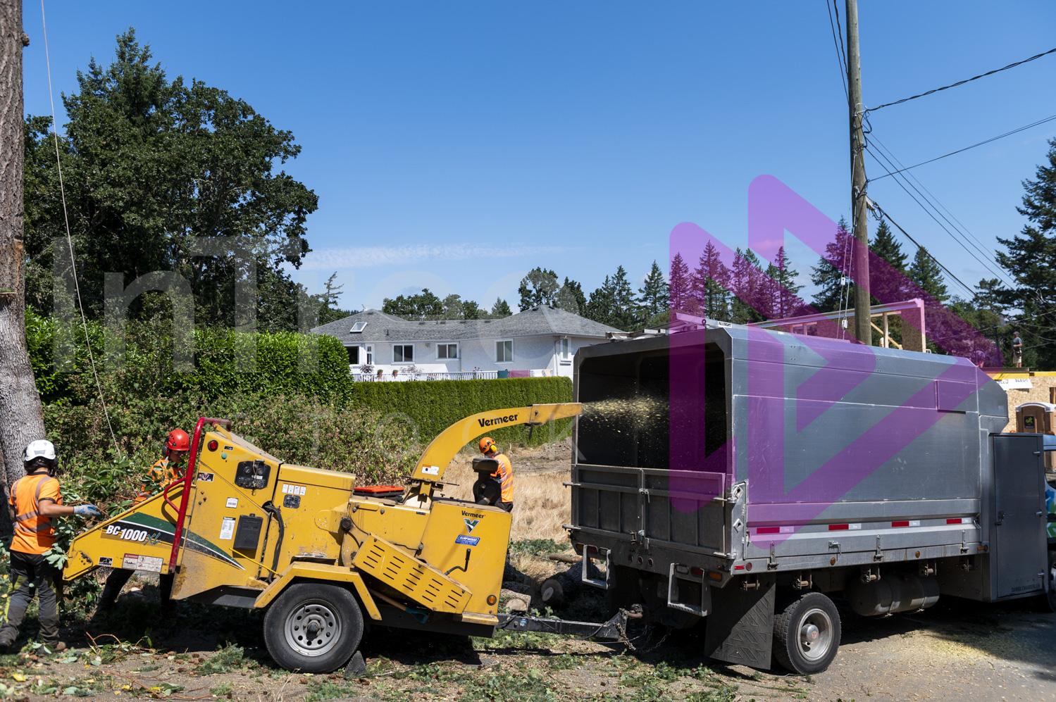 Ground crew chipping branches