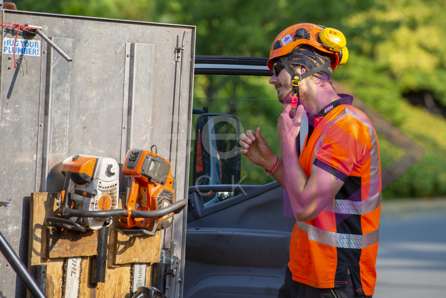 Man removing orange helmet