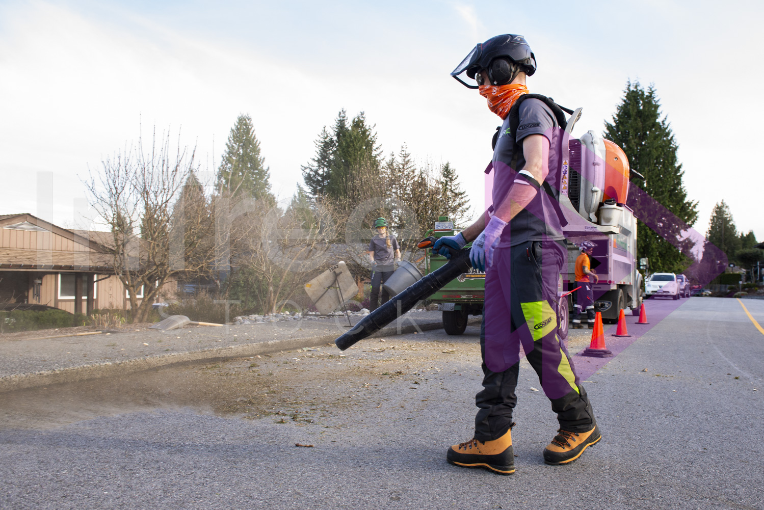 Man with backpack blower on road