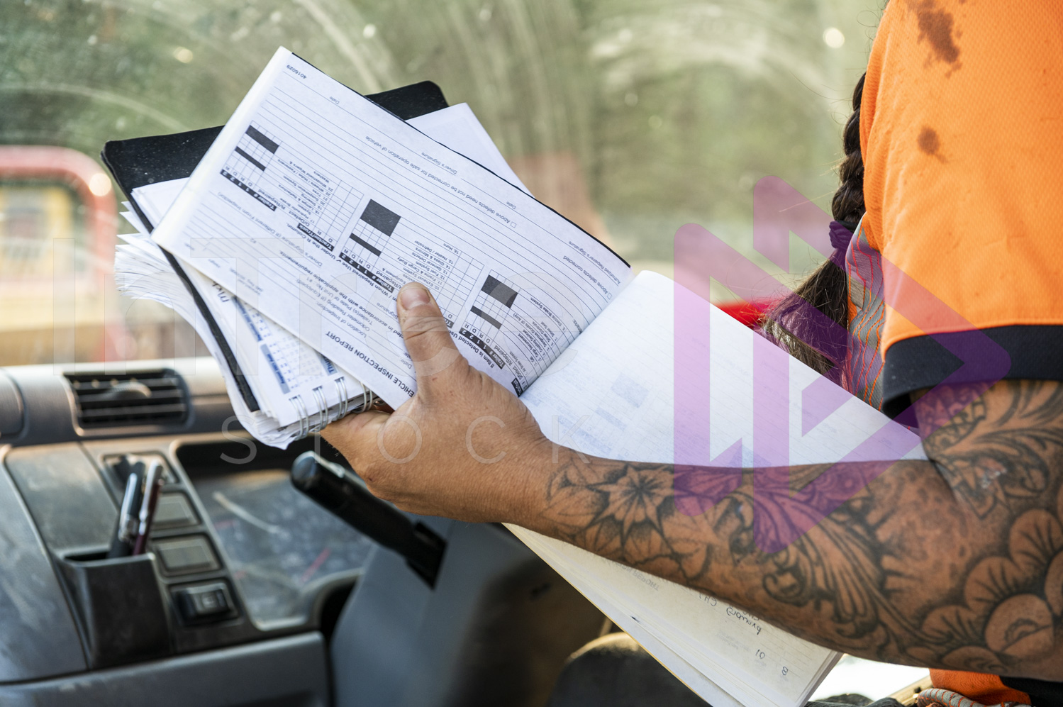 Vehicle inspection report form held in female's hand