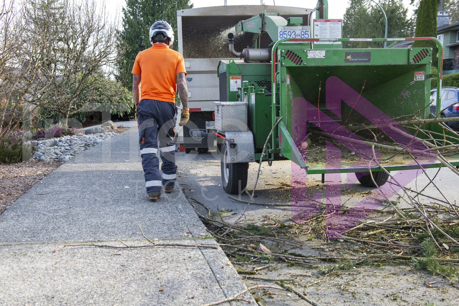Man walking past wood chipper