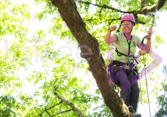 Female arborist at tree climbing competition