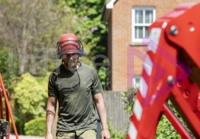 Man carrying outrigger pads to spider lift