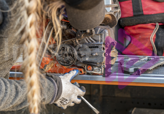 Chainsaw-maintenance Woman cleaning and maintaining chainsaw