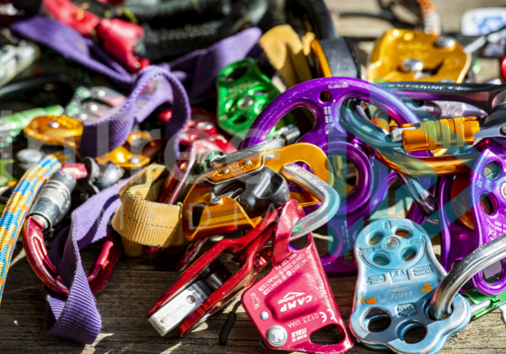 Climbing hardware ascenders pulleys carabiners Colourful pile of climbing hardware, ascenders, pulleys carabiners
