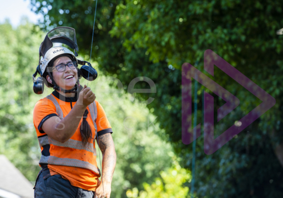 Female arborist smiling with throw line