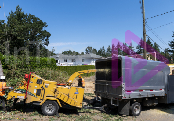 Ground crew chipping branches