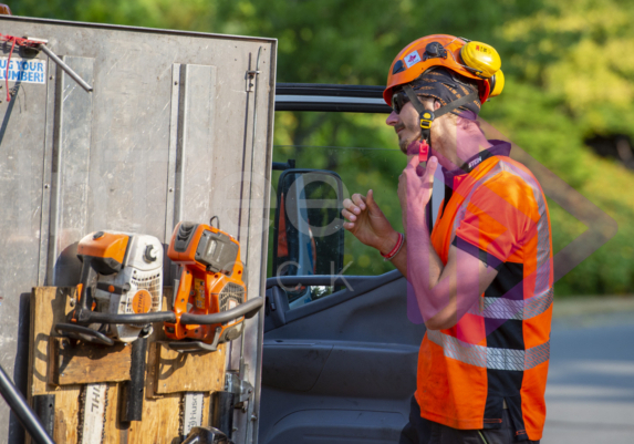 Man removing orange helmet