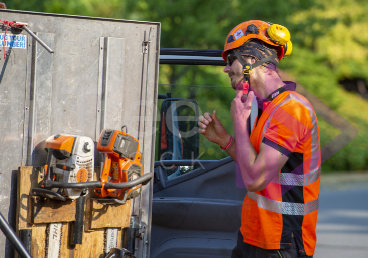 Man removing orange helmet Man removing orange helmet
