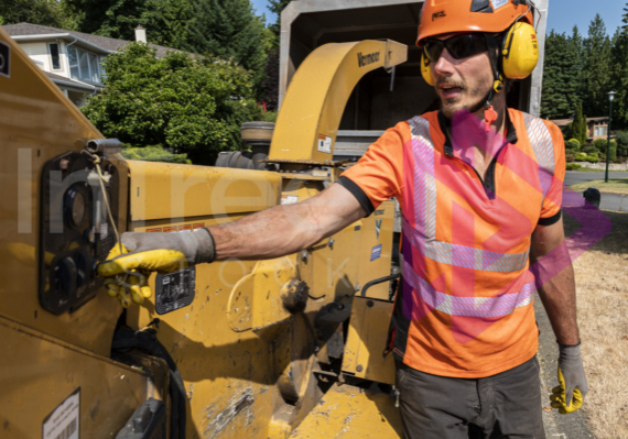 Man turning on Vermeer chipper - Arborist Stock Photo-001-21-3609 Man turning on Vermeer chipper