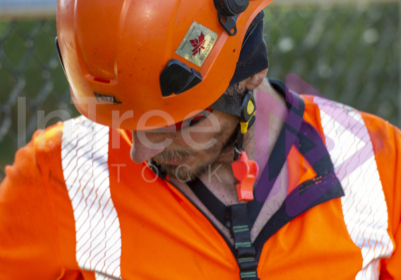 Man wearing orange helmet and hi-vis with SRT chest harness