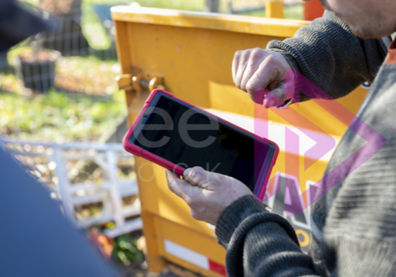 Man operating a tablet with blank screen ready for mock up