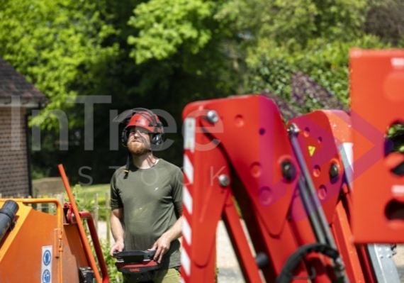 Spider lift operator moving lift with remote control