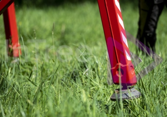 Spider lift leg in long green grass