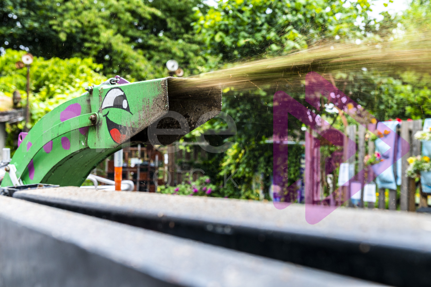 Chipper chute with a smiling face painted on it