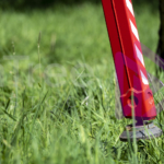 Spider lift leg in long green grass