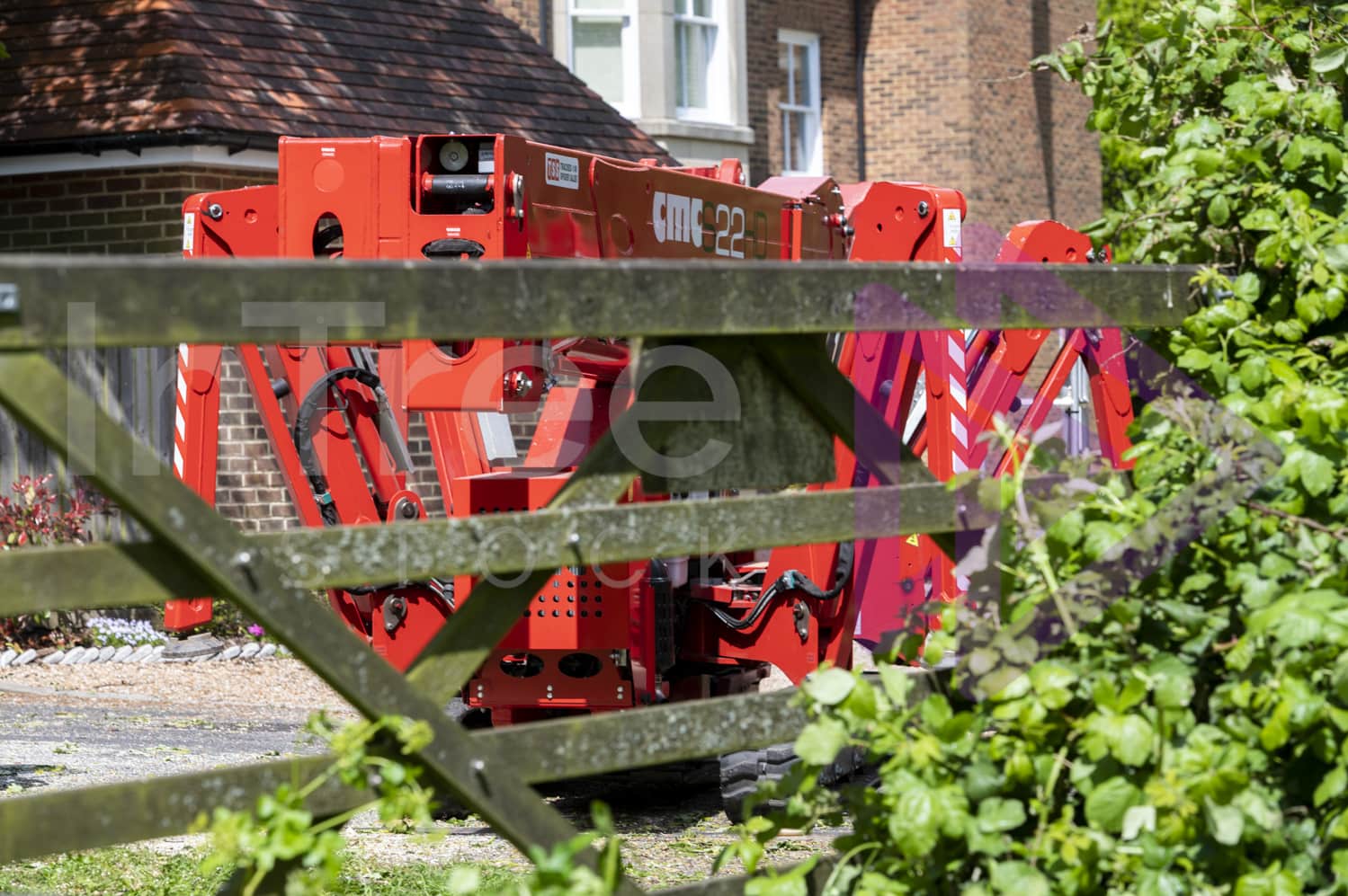 Tracked spider lift moving through gateway